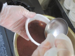 あずきの汁を器に入れている写真